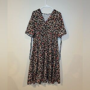 Knee length floral multicolor dress in a size medium with a V-neck and back tie.